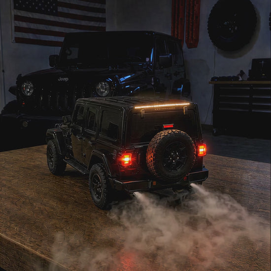 Mist humidifier running at night: tail lights glowing and mist rolling out of the exhausts